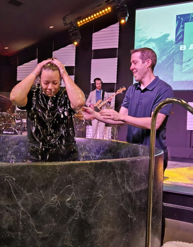 Get Baptized In Greensboro, Nc Heavily baptizing a young woman in a church service at grace life church.